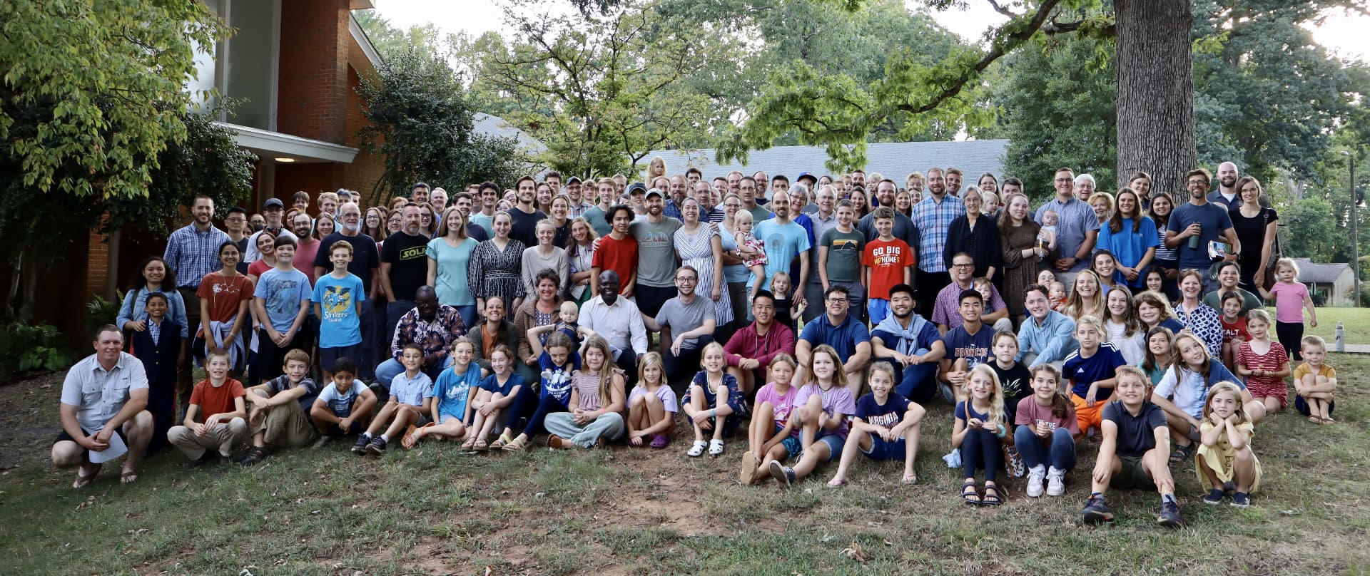 The congregation of Jefferson Park Baptist Church gathered together on the church lawn under the oak trees